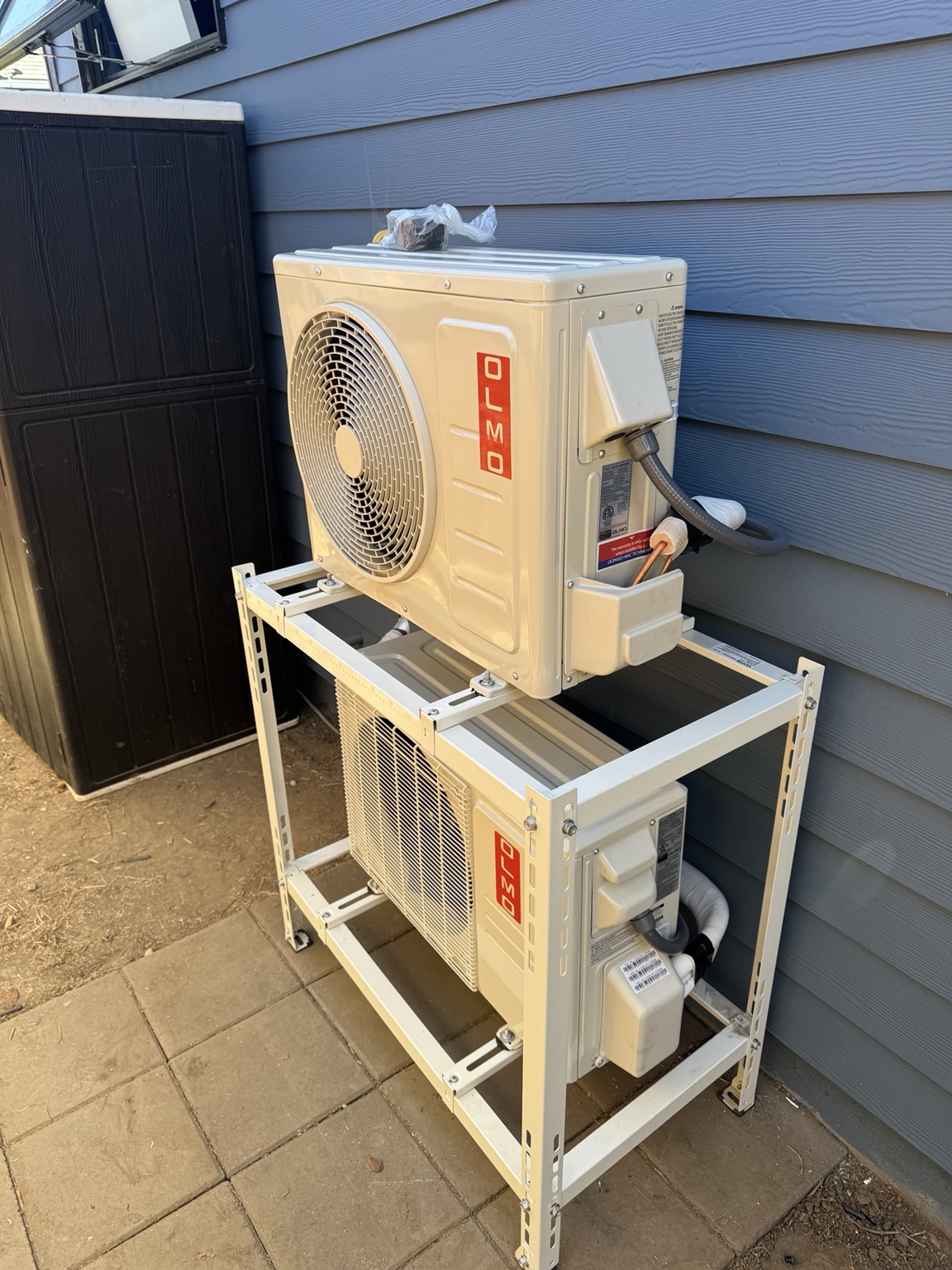 Two outdoor mini-split units installed on equipment rack